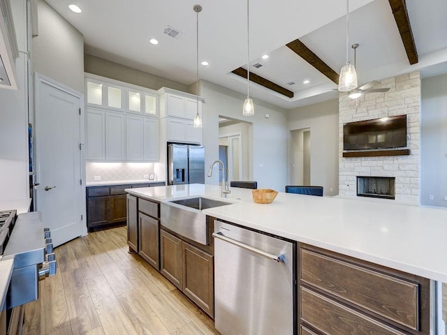 19516 Tranquility Falls Path, Lago Vista, TX 78645 - kitchen featuring appliances with stainless steel finishes, a ceiling fan, light wood-type flooring, decorative backsplash, and light countertops