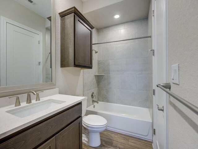 19516 Tranquility Falls Path, Lago Vista, TX 78645 - bathroom featuring vanity, wood finished floors, shower / bath combination, and a textured wall