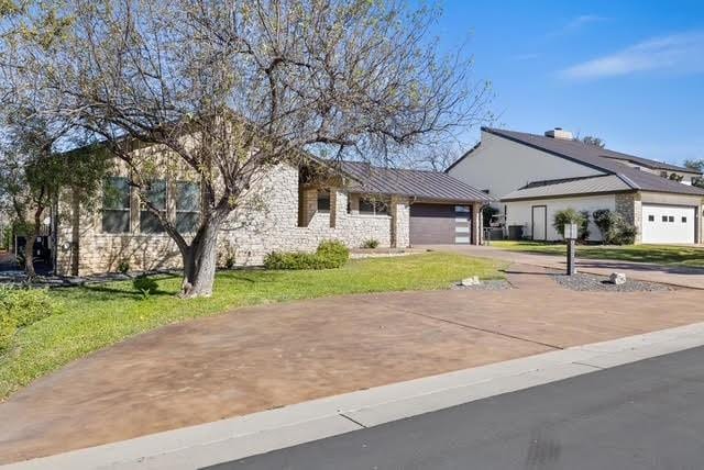 ranch-style house with a front yard and a garage