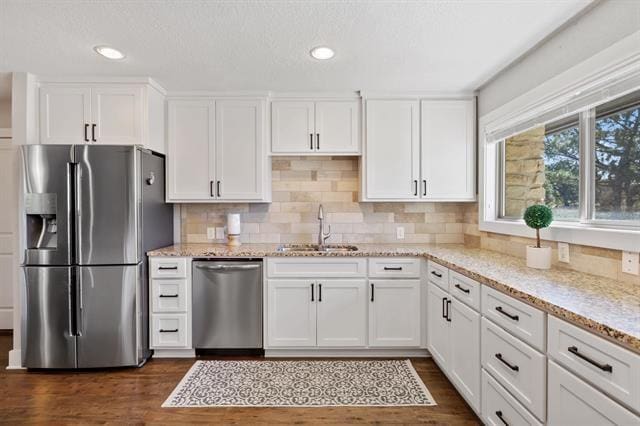 kitchen featuring sink, white cabinetry, and stainless steel appliances