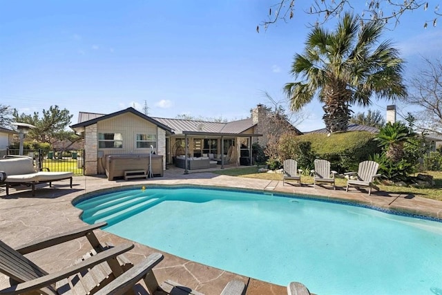 view of pool with a patio area and a hot tub