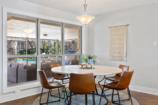 dining space featuring dark wood-type flooring