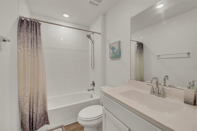 full bathroom with hardwood / wood-style floors, vanity, toilet, and shower / bathtub combination with curtain