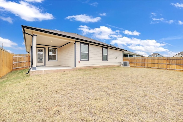 rear view of property with a patio area and central AC