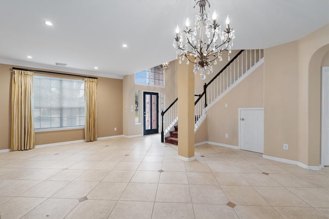 entrance foyer featuring light tile patterned flooring and an inviting chandelier