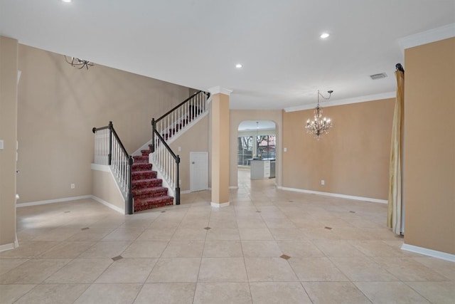 spare room featuring light tile patterned floors, an inviting chandelier, and crown molding