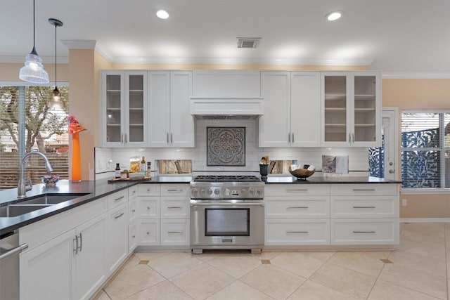 kitchen with decorative backsplash, sink, stainless steel appliances, and hanging light fixtures