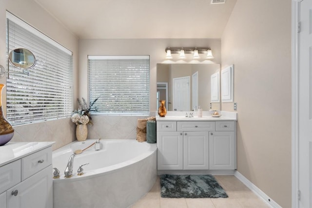 bathroom with tile patterned flooring, vanity, and a tub