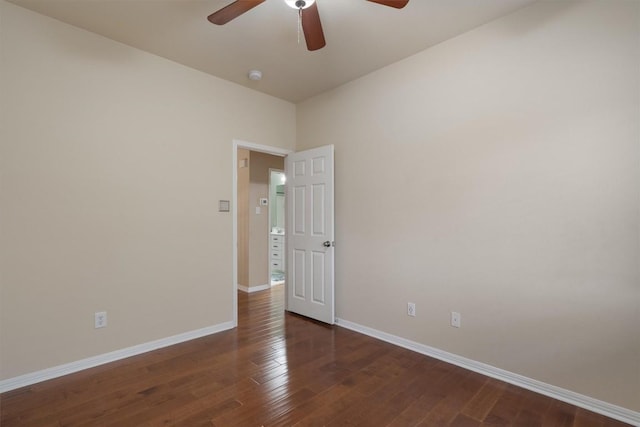 spare room with dark hardwood / wood-style floors and ceiling fan