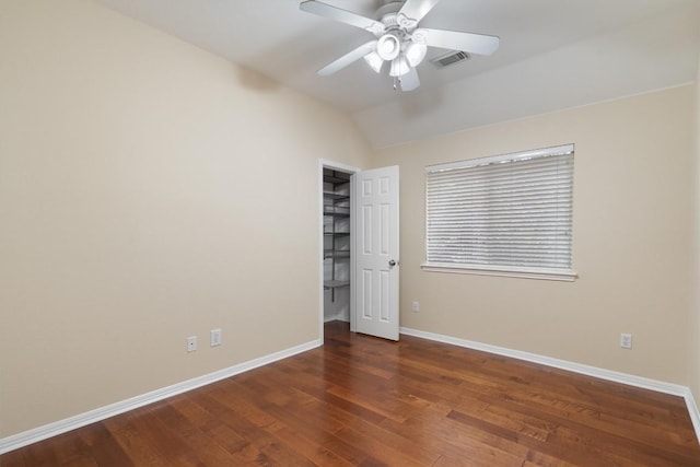 unfurnished bedroom with ceiling fan, dark wood-type flooring, and vaulted ceiling