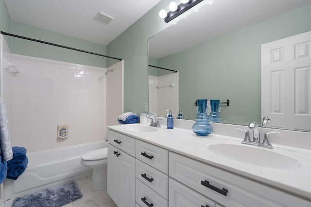 full bathroom with vanity, tiled shower / bath combo, and toilet