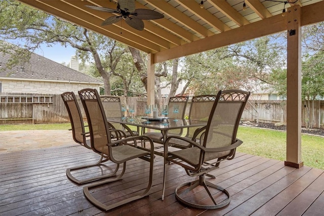 deck with a lawn and ceiling fan