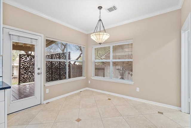 unfurnished dining area with light tile patterned floors and ornamental molding