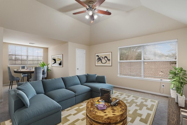 living room with light carpet, plenty of natural light, and vaulted ceiling