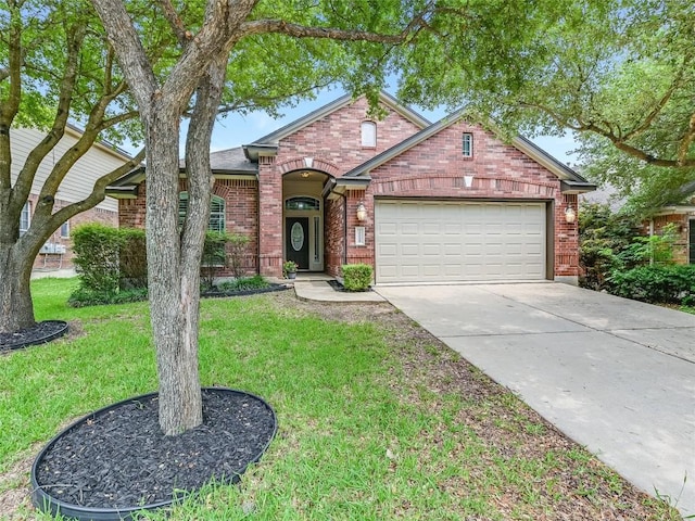 view of front of home with a front yard and a garage