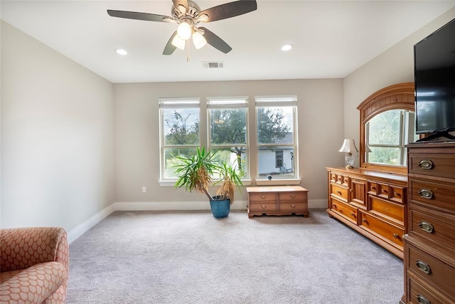 living area with carpet flooring and ceiling fan