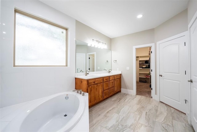 bathroom with vanity and a tub to relax in