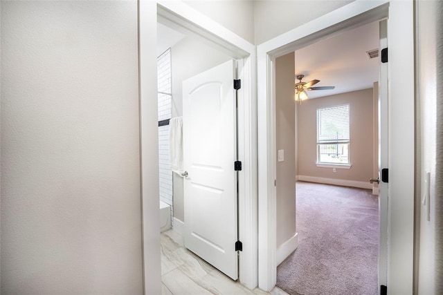 hallway with light colored carpet