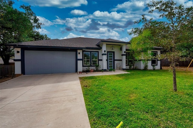 view of front of property featuring a garage and a front yard