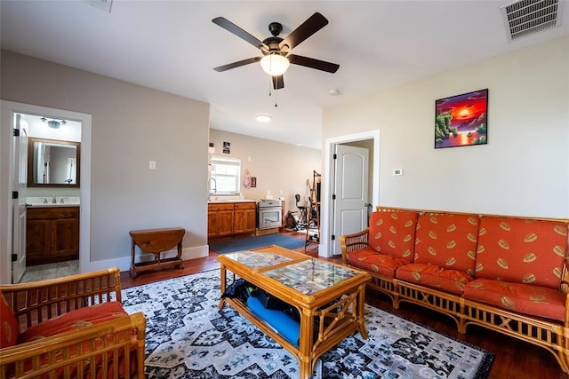 living room with wood-type flooring, ceiling fan, and sink