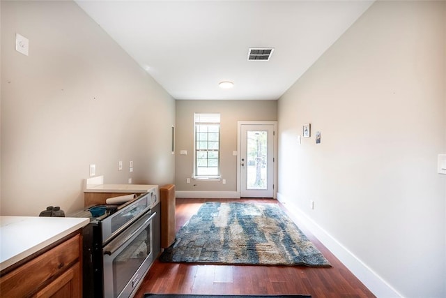 doorway with dark wood-type flooring