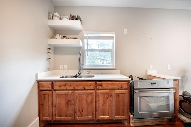 kitchen with wall oven, sink, and stove