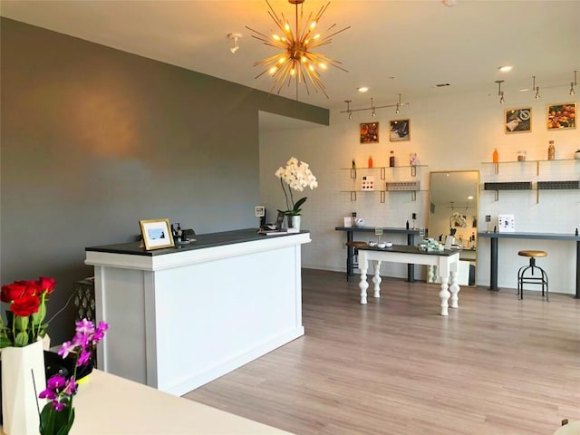 4361 S Congress Ave Unit 106, Austin, TX 78745 - kitchen with a chandelier, wood finished floors, track lighting, and recessed lighting