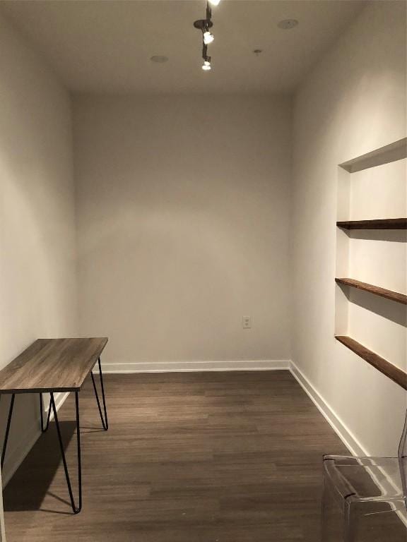 4361 S Congress Ave Unit 106, Austin, TX 78745 - spare room featuring dark wood-type flooring, built in shelves, and track lighting