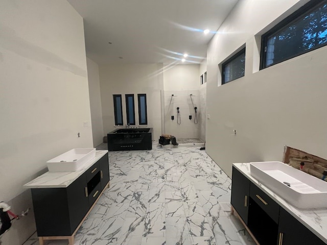 bathroom with vanity and tiled shower