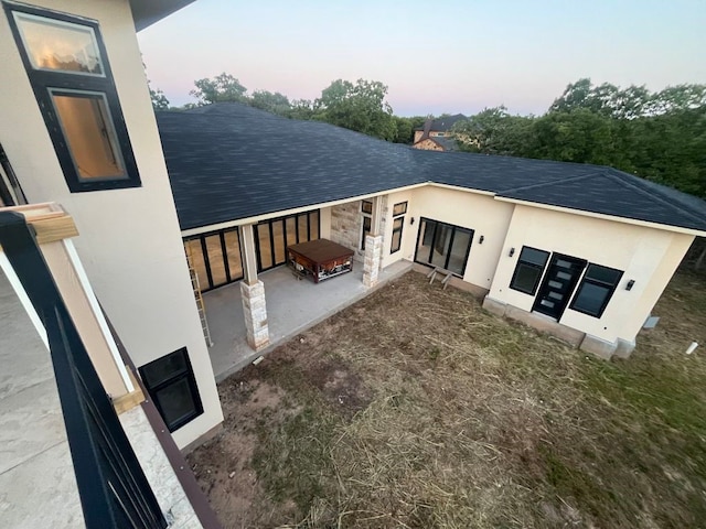 view of back house at dusk