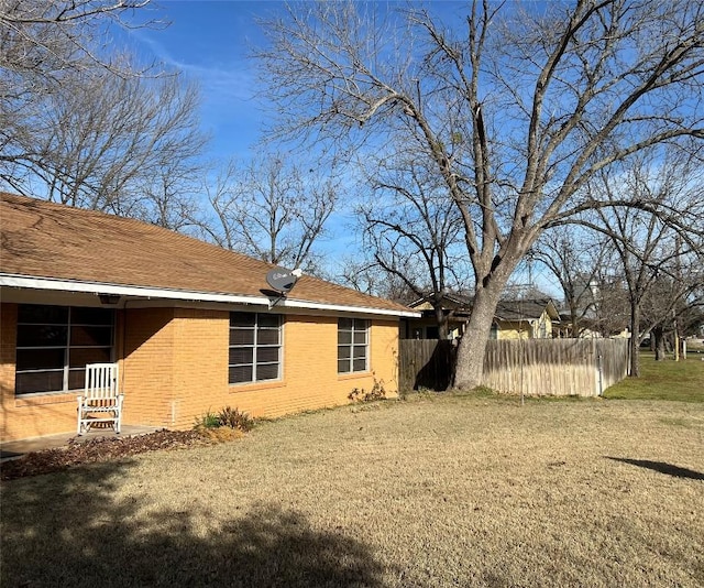 view of side of property with a yard