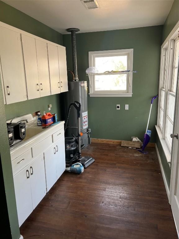 kitchen with white cabinetry and dark wood-type flooring