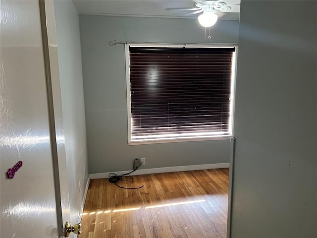 spare room with hardwood / wood-style flooring and ceiling fan