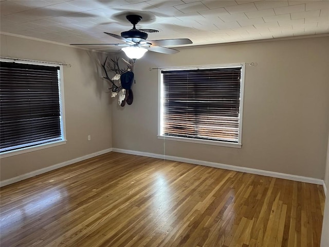 empty room featuring hardwood / wood-style flooring and ceiling fan