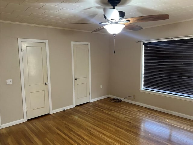 unfurnished bedroom with hardwood / wood-style flooring, ceiling fan, and crown molding