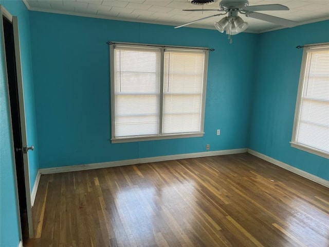 unfurnished room featuring crown molding, ceiling fan, and dark wood-type flooring