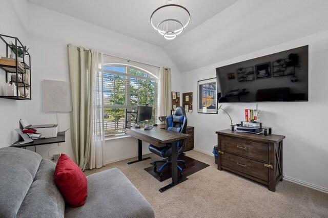 office featuring a notable chandelier, a wealth of natural light, vaulted ceiling, and light colored carpet