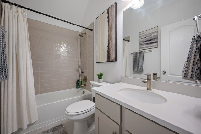 full bathroom with lofted ceiling, tile patterned flooring, vanity, shower / bath combination with curtain, and toilet