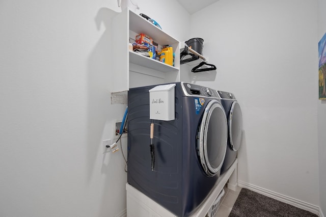 laundry room featuring washing machine and clothes dryer and tile patterned flooring