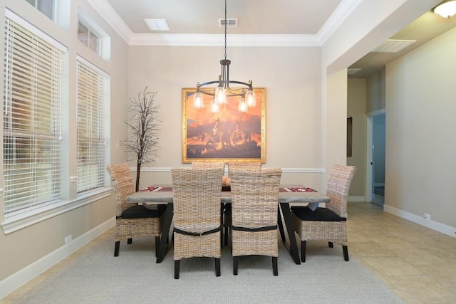 dining space featuring crown molding and a chandelier