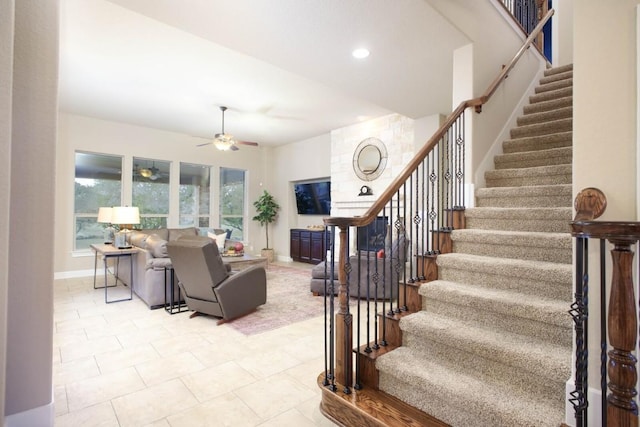 living room with ceiling fan and light tile patterned flooring