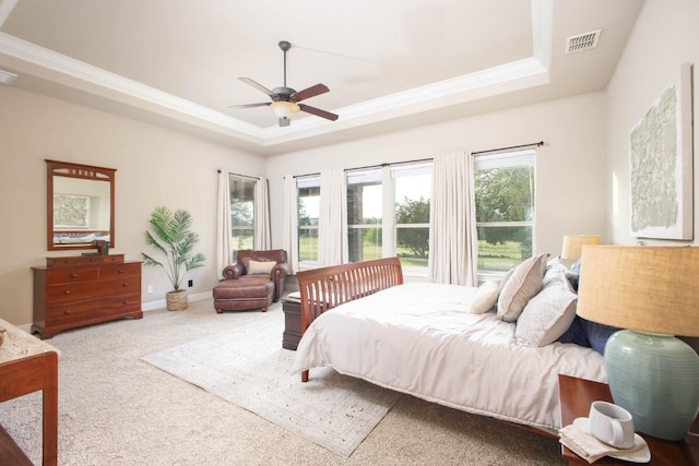 bedroom with carpet, a raised ceiling, and ceiling fan