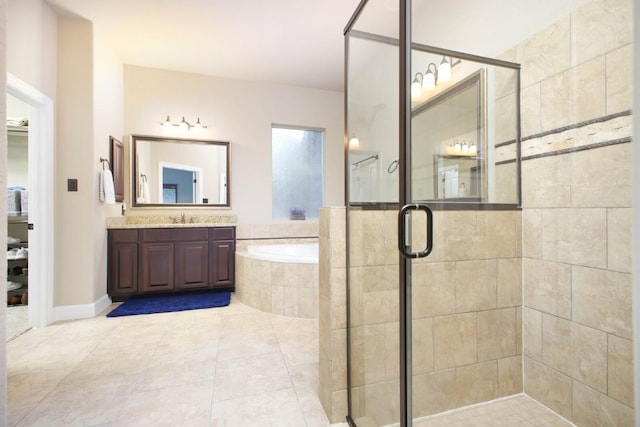 bathroom featuring vanity and independent shower and bath