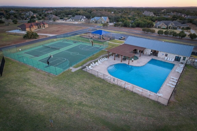 pool at dusk featuring basketball hoop