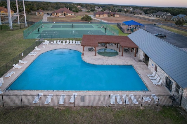 view of pool at dusk