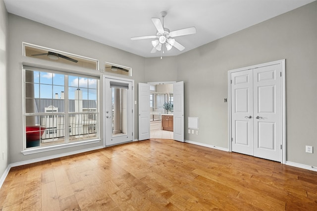 empty room with ceiling fan and light hardwood / wood-style floors