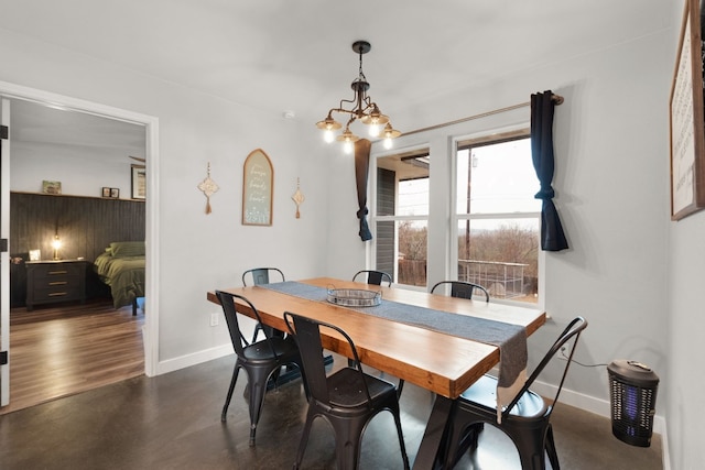 dining space with dark hardwood / wood-style floors and a chandelier