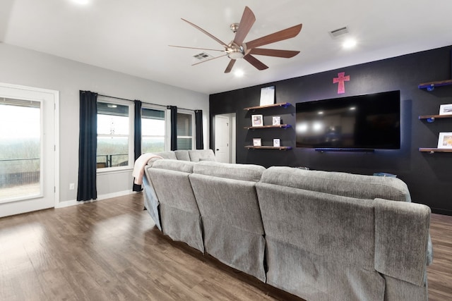 living room with wood-type flooring and ceiling fan