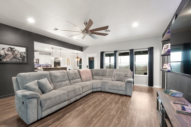 living room with dark hardwood / wood-style floors and ceiling fan