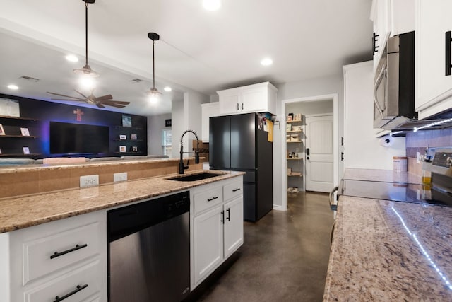 kitchen featuring stainless steel dishwasher, white cabinets, sink, and hanging light fixtures